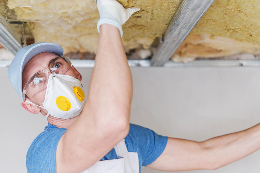 An Affordable Roof Maryland technician checking the roofing insulation for energy efficiency. 